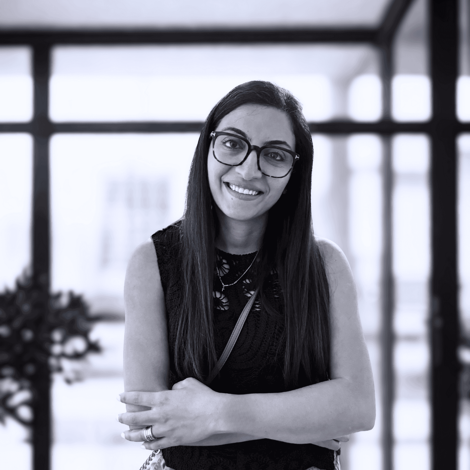 Solange Phillipe, founder of Web Neuro, a Canadian digital marketing company in Calgary, smiling confidently in a modern office setting.